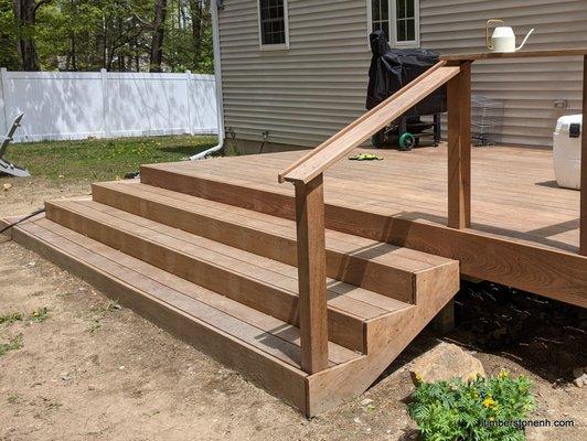 Ipe hardwood deck with an wide staircase to engage the yard.