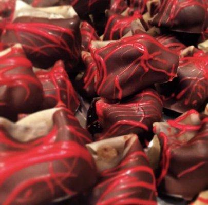 Chocolate dipped chocolate chip cookie wontons drizzled with the red for Valentine's Day