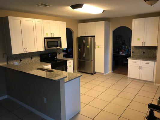 White Shaker cabinets and Luna Pearl granite