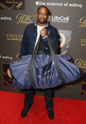 Actor, Dule Hill, working out his muscles with GBK's Golden Globes swag bag.