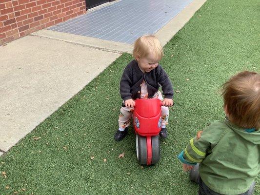 My daughter on the toddler playground enjoying the bikes!