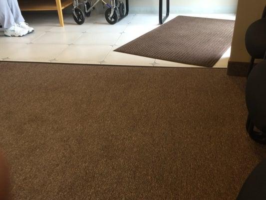 Here you can see as you walk through the door there is a carpet laid down as well as transition from time to carpet