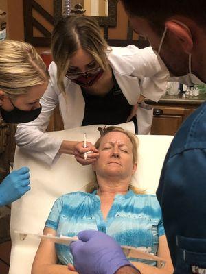 Aesthetic injector Jennelle training healthcare professionals to get certified in Botox and Dermal Filler