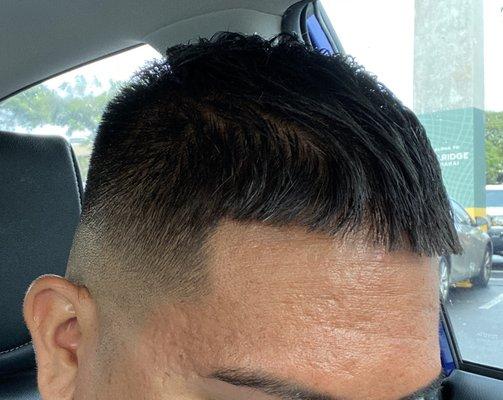 Mid skin fade with textured top and line up