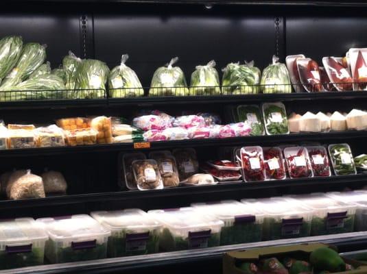 Refrigerated produce in the back. The tupperware bins at the bottom contain numerous types of fresh herbs.