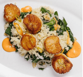 Seared Scallops over Wilted Greens and Cous-Cous