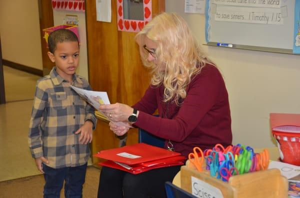 Our 4k Aide checking this student's work.