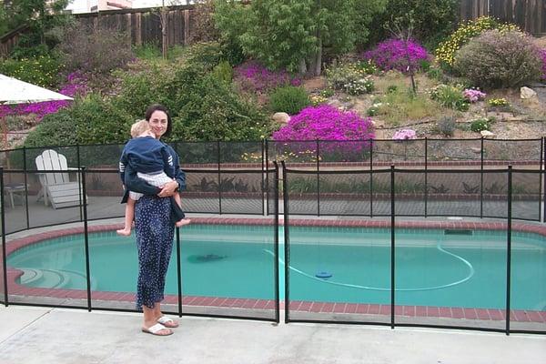 mother and child near pool fence