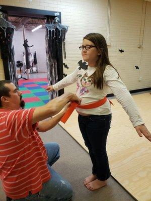 Emma receives her orange belt