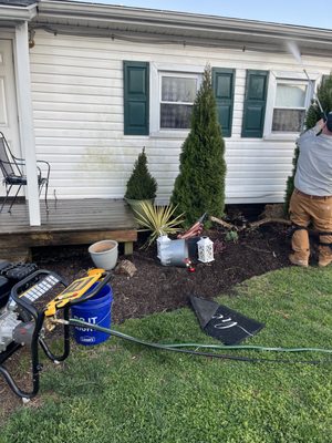 Pressure washing exterior of a house