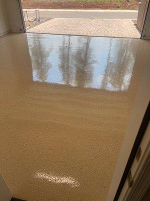 Garage floor freshly coated. View from kitchen door going into garage.