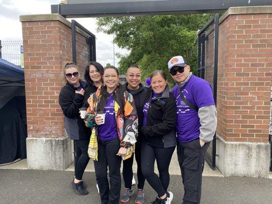 6 people take a photo after participating in an Alzheimer's Awareness walk