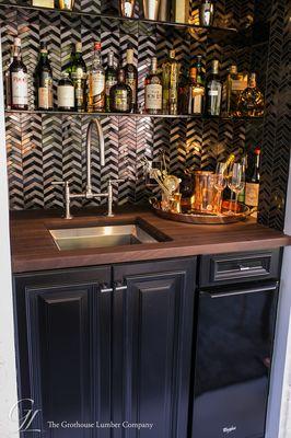 This mini bar designed by Steven Miller features a Grothouse Edge Grain bar area countertop in peruvian walnut.