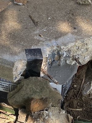 Broken concrete on a porch before my repair