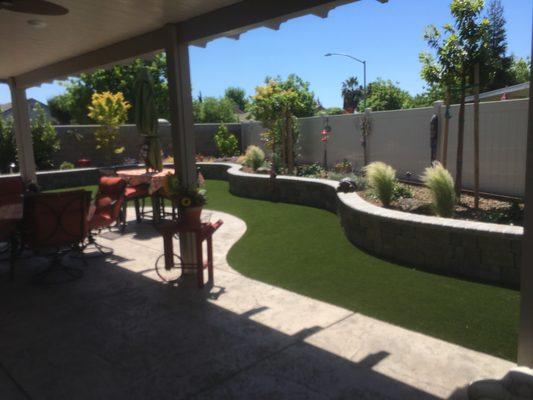 Raised planter beds with artificial turf.