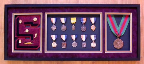 Custom shadow box framing of swim and dive medals and memorabilia