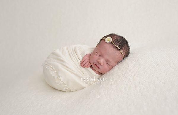 Wrapped up newborn portrait by Add to Heart Photography