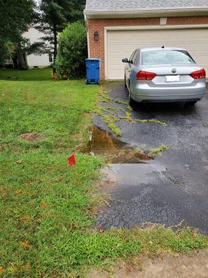 Drainage issues and manhole cover presents challenges.