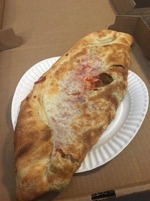 Calzone with hot peppers, sausage, meatball and broccoli