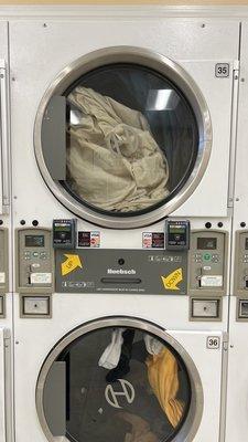 Big dryers, 25¢ per 5 minutes. I suggest quarters over the card so you can stack the time and leave.