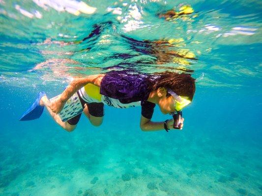 We captured this image of Dhruv's first time snorkeling in the vibrant blue waters of Maui Hawaii