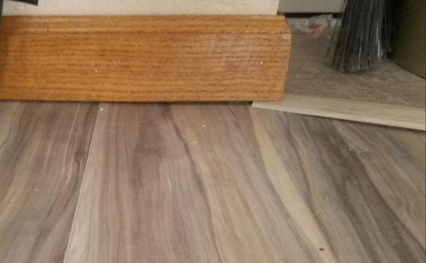 See the gap caused by shoving transition under the baseboard?