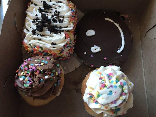 Clockwise from top left: chocolate cake, chocolate smile cookie, vanilla cupcakes with vanilla and chocolate frosting