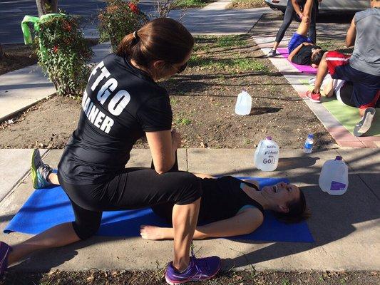 FTGO trainer helping a client stretch