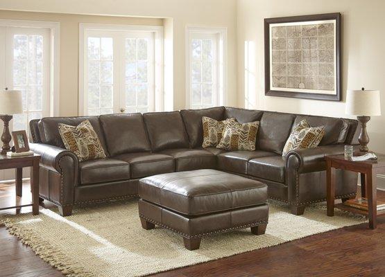 The Escher sectional is a traditional style sectional with rolled arms, nailhead trim and 100% leather in chocolate brown. #1 Seller!