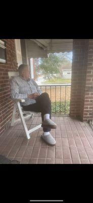 Sitting watching a client enjoy sitting on his porch