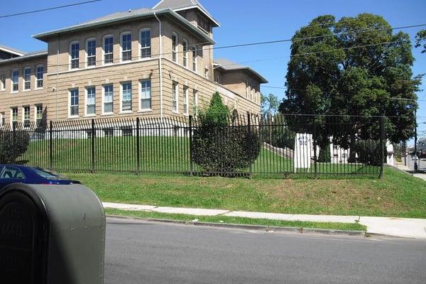 Building photo. Our parking lot entrance is located on Basin Street and offices are on the 2nd floor.