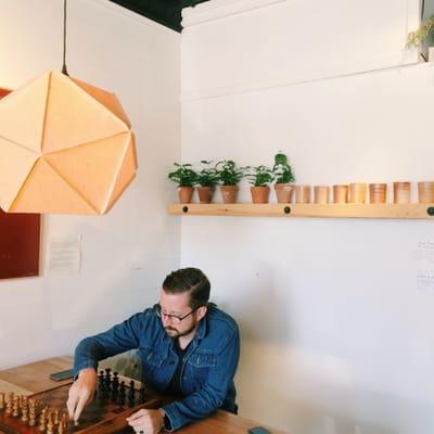 Inside the shop. Coffee plants, awesome lamp shades & a great seating area