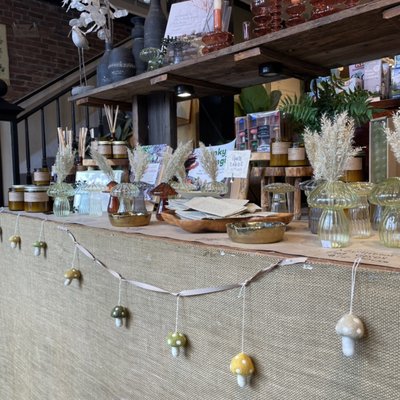 Front display table with cute glass mushroom bud vases, great smelling candles and beautiful glass candlesticks.