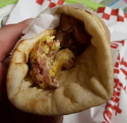 The breakfast pita is about half full