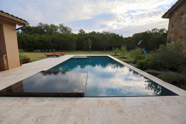 Infinity edge stainless steel pool and spa