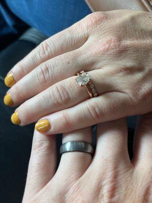 A pair of wedding bands and an engagement ring from TWJE - plus the hands of two happy customers!