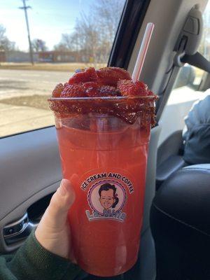 Strawberry Aguas Frescas, topped with fresh strawberries, chamoy, and tajin!