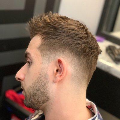 Low skin fade Haircut with textured top and beard sculpt/trim