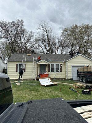 New roof installation with traditional masonry chimney removal and replacing with metal chimney pipe