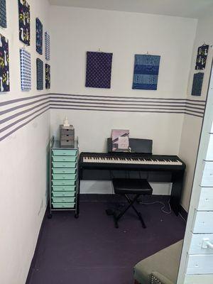 The new studio's keyboard area! Loving the music staff painted on the walls!