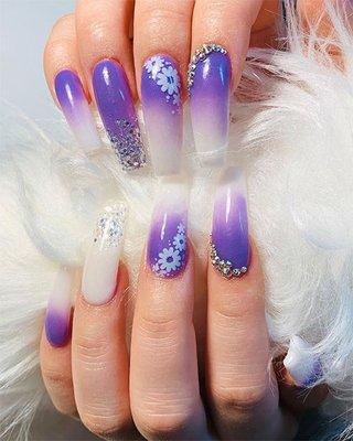 So cute purple ombre nails adorned with glitter flowers and crystals