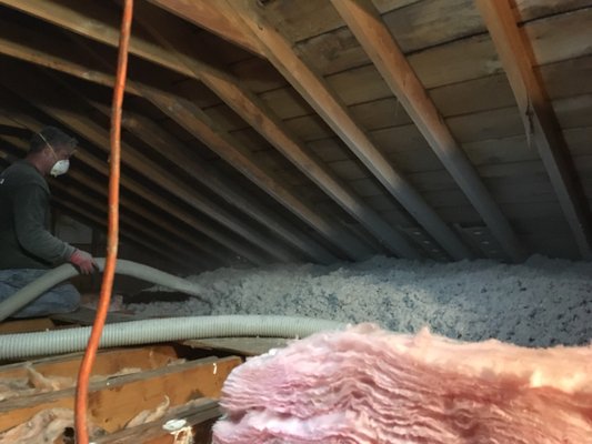 Insulation being blown into attic