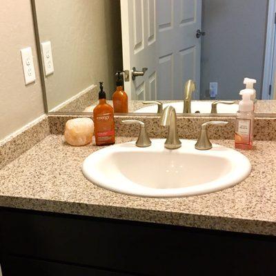 I transformed this tiny powder room by swapping out boring white marble, with unique speckled granite!