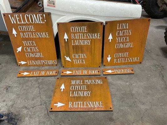 Boutique hotel signage in rust patina. We love the white lettering