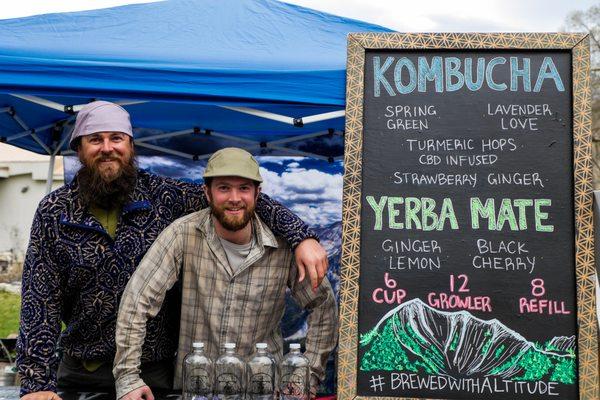 Hayden and Stove sharing kombucha and mate at the farmer's market.