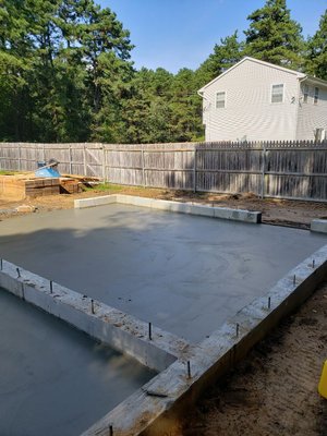 Complete construction of concrete foundation walls and slab for garage and shed.