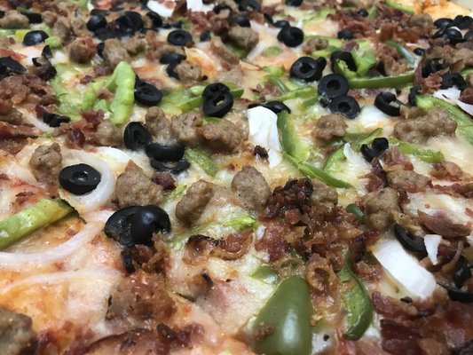 Party pizza anyone? Topped with bacon, sausage, peppers, onions, black olives... for LESS than $25!