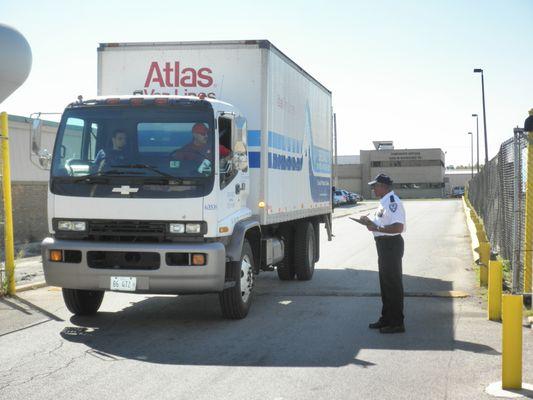 American Security Services security guard completing a trucking and transportation security point check in