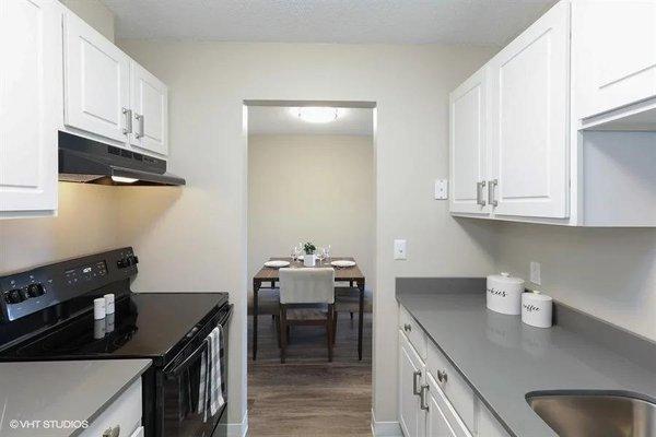 Updated kitchen with all blakc appliances with a glass stove-top. Quartz counter tops and plenty of cabinet and counter space.