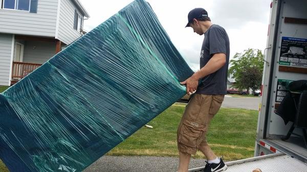 Sam and Waylon bringing a nicely pad wrapped dresser into the truck! Call us and #MakeYourNextMoveYourBestMove